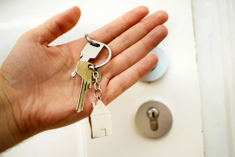 a person holding a house key
